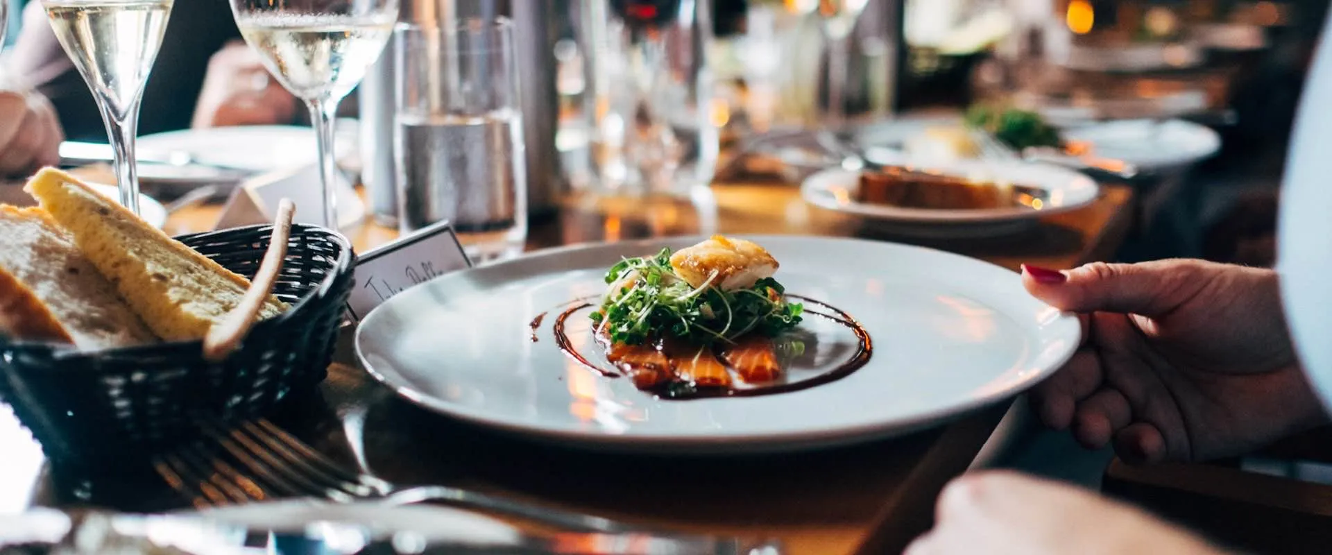 Warm restaurant interior with team at work